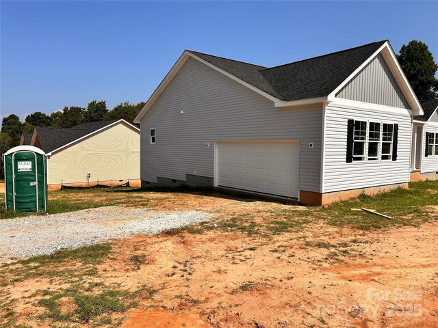 3500 14th Ave SW, Hickory, NC 28602 - view of side of property with gravel driveway, a shingled roof, and a garage