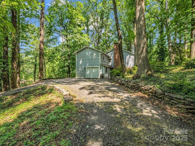 1463 Carolina Dr, Tryon, NC 28782 - view of outbuilding with asphalt driveway and an attached garage