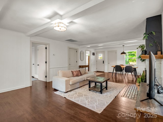1463 Carolina Dr, Tryon, NC 28782 - living room featuring wood finished floors, a chandelier, wainscoting, and a decorative wall