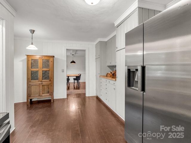 1463 Carolina Dr, Tryon, NC 28782 - kitchen with stainless steel refrigerator with ice dispenser, dark wood-style floors, crown molding, white cabinetry, and hanging light fixtures