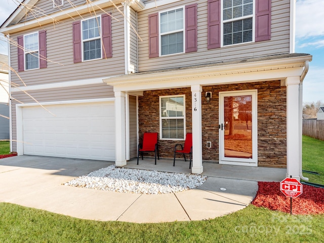 4316 Davis Meadows Dr, Charlotte, NC 28216 - view of front of house featuring covered porch, stone siding, an attached garage, and driveway