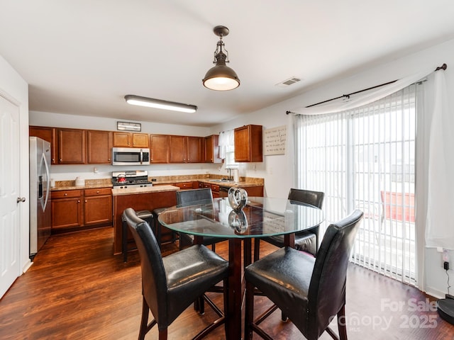 4316 Davis Meadows Dr, Charlotte, NC 28216 - dining room with healthy amount of natural light and dark wood finished floors