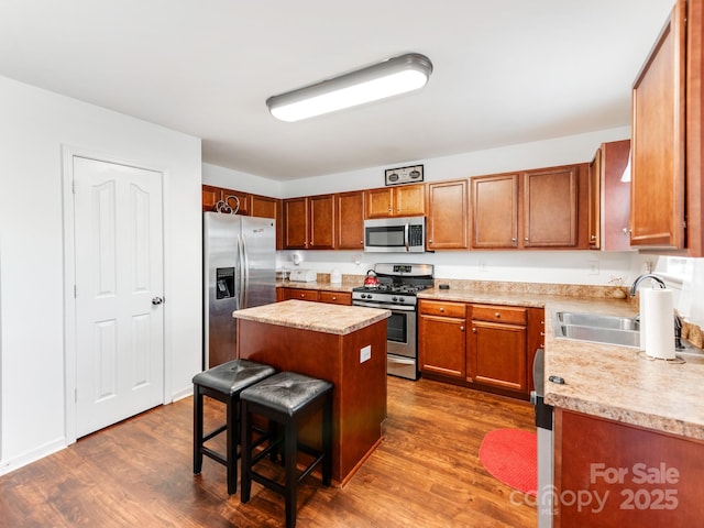 4316 Davis Meadows Dr, Charlotte, NC 28216 - kitchen with appliances with stainless steel finishes, a center island, light countertops, and dark wood finished floors