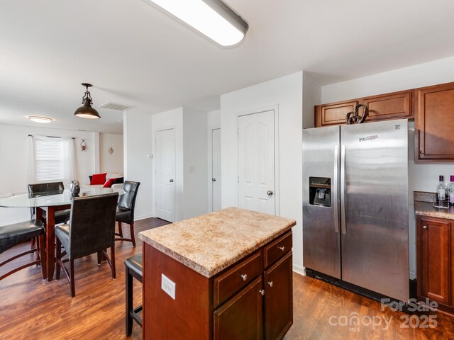 4316 Davis Meadows Dr, Charlotte, NC 28216 - kitchen featuring stainless steel refrigerator with ice dispenser, dark wood-style flooring, light countertops, and hanging light fixtures