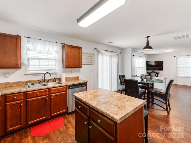4316 Davis Meadows Dr, Charlotte, NC 28216 - kitchen featuring stainless steel dishwasher, dark wood-style flooring, light countertops, and healthy amount of natural light