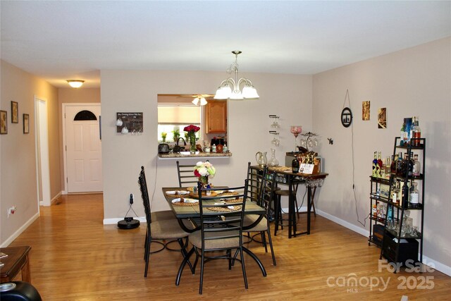 544 Tracy Grove Rd, Flat Rock, NC 28731 - dining room featuring light wood finished floors and a chandelier