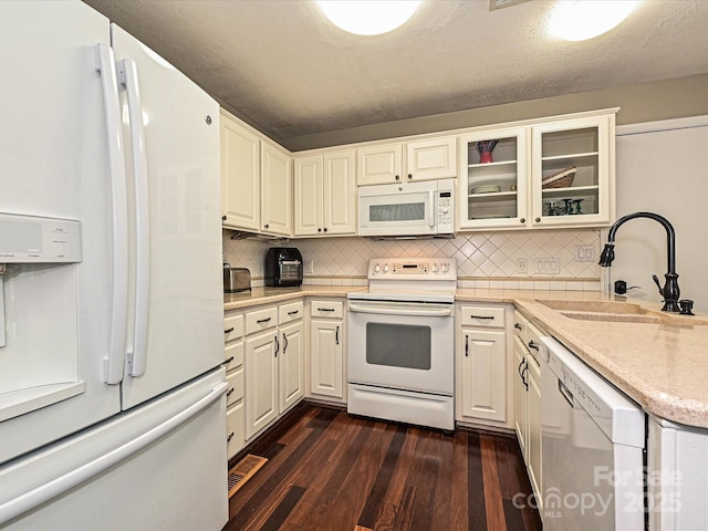 2621 Brightmoor Ridge Dr, Matthews, NC 28105 - kitchen with white appliances, dark wood finished floors, backsplash, glass insert cabinets, and a peninsula