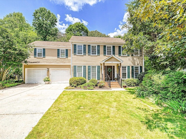 2621 Brightmoor Ridge Dr, Matthews, NC 28105 - colonial-style house featuring driveway, an attached garage, and a front lawn