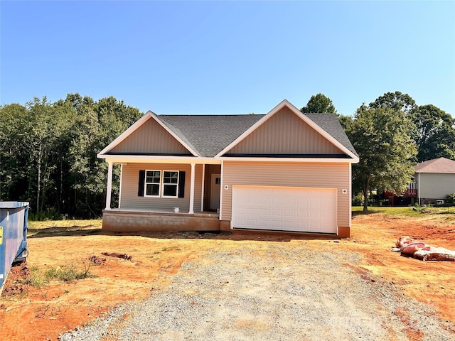 3506 14th Ave SW, Hickory, NC 28602 - view of front of house with covered porch, a shingled roof, a garage, and dirt driveway