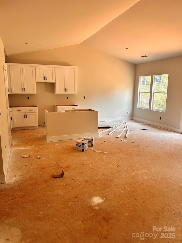3506 14th Ave SW, Hickory, NC 28602 - kitchen with white cabinetry, vaulted ceiling, and a kitchen island