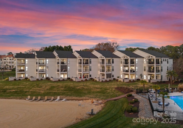 17811 Half Moon Ln Unit E, Cornelius, NC 28031 - property at dusk with a community pool and a residential view