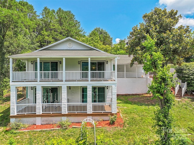 371 Clearview Dr, Waynesville, NC 28786 - view of front of house with a balcony, a porch, a front yard, and a shingled roof