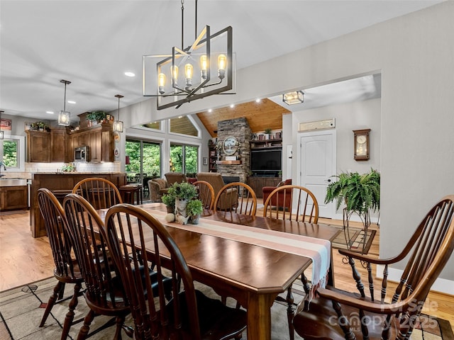 3094 Connestee Trl, Brevard, NC 28712 - dining space with healthy amount of natural light, lofted ceiling, a chandelier, recessed lighting, and light wood-type flooring