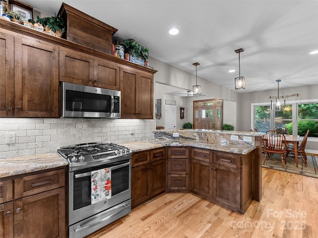 3094 Connestee Trl, Brevard, NC 28712 - kitchen with stainless steel appliances, light wood-type flooring, decorative backsplash, decorative light fixtures, and recessed lighting