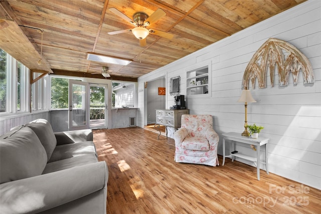 4534 Pebblebrook Cir SW, Concord, NC 28027 - living room with wood ceiling, ceiling fan, wood finished floors, and wooden walls