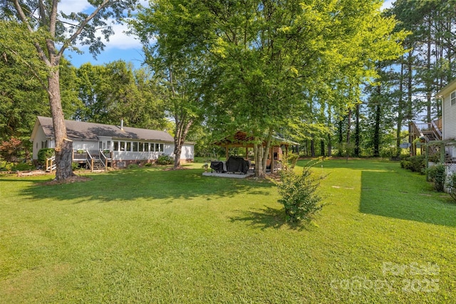 4534 Pebblebrook Cir SW, Concord, NC 28027 - view of grassy yard with a gazebo and a wooden deck