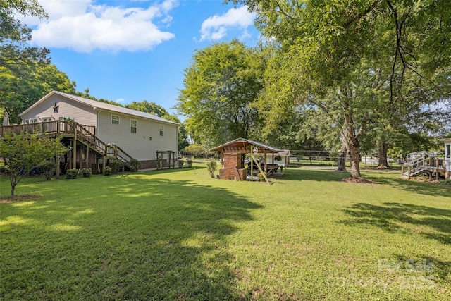 4534 Pebblebrook Cir SW, Concord, NC 28027 - view of yard featuring stairs, a wooden deck, and an outbuilding