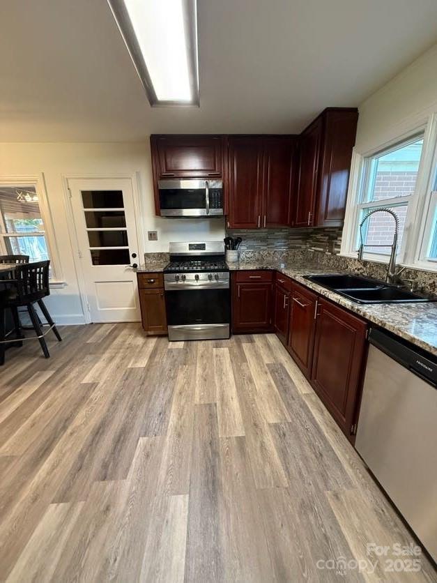 148 Barium Ln, Statesville, NC 28677 - kitchen with stainless steel appliances, light wood finished floors, plenty of natural light, and stone countertops