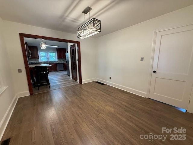 148 Barium Ln, Statesville, NC 28677 - unfurnished dining area with dark wood-style floors and baseboards