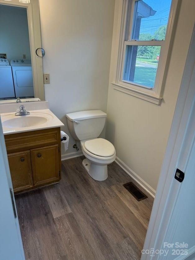 148 Barium Ln, Statesville, NC 28677 - half bathroom featuring independent washer and dryer, vanity, and wood finished floors