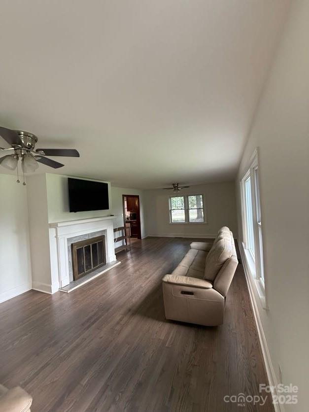 148 Barium Ln, Statesville, NC 28677 - living area with dark wood-type flooring, a ceiling fan, and a high end fireplace