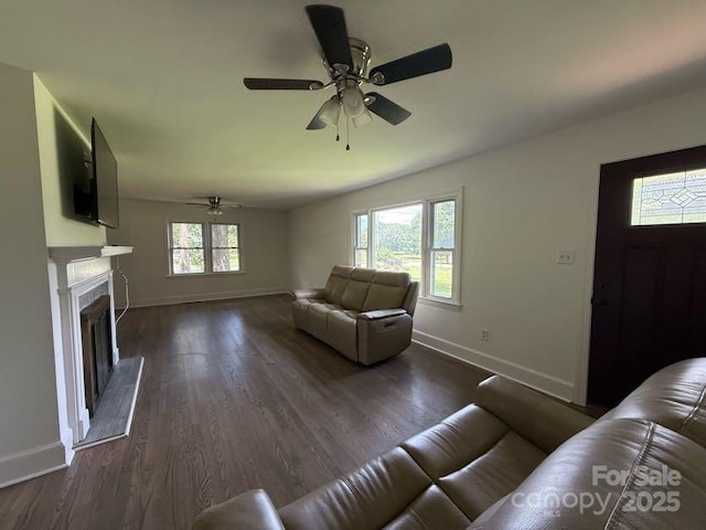 148 Barium Ln, Statesville, NC 28677 - living room featuring ceiling fan, dark wood-type flooring, and a fireplace with raised hearth