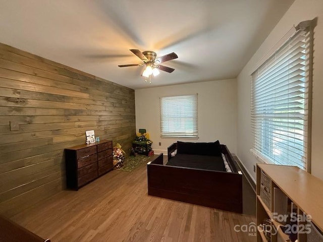 148 Barium Ln, Statesville, NC 28677 - bedroom with wooden walls, light wood-style flooring, and a ceiling fan