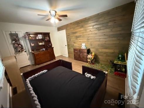 148 Barium Ln, Statesville, NC 28677 - living area featuring a ceiling fan, wooden walls, and wood finished floors