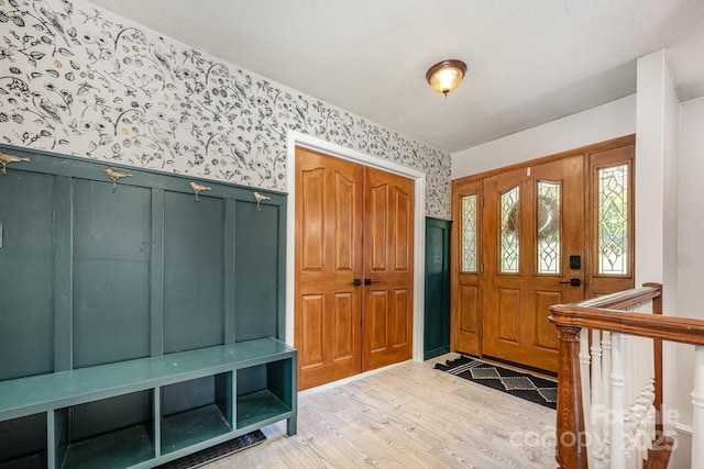 301 Rosemont Ave SE, Concord, NC 28025 - foyer entrance with wallpapered walls, light wood finished floors, a textured ceiling, and wainscoting