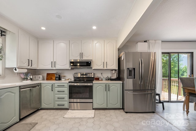 301 Rosemont Ave SE, Concord, NC 28025 - kitchen featuring stainless steel appliances, green cabinetry, light countertops, recessed lighting, and white cabinets
