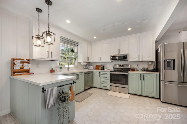 301 Rosemont Ave SE, Concord, NC 28025 - kitchen featuring stainless steel appliances, green cabinets, recessed lighting, white cabinetry, and light countertops