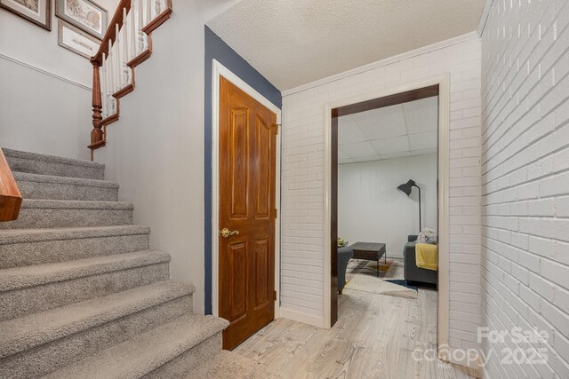 301 Rosemont Ave SE, Concord, NC 28025 - stairs featuring wood finished floors and brick wall