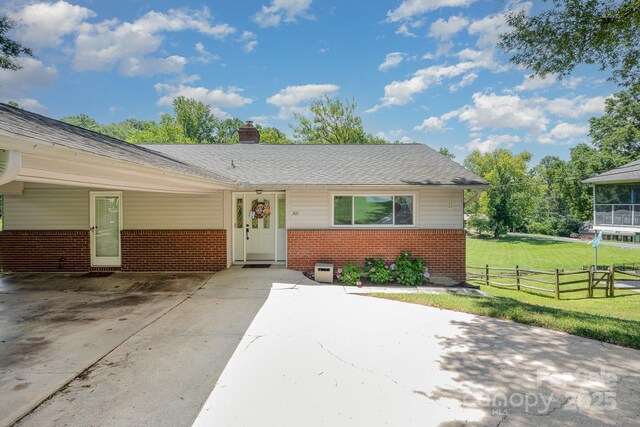 301 Rosemont Ave SE, Concord, NC 28025 - ranch-style house with brick siding, a chimney, and concrete driveway