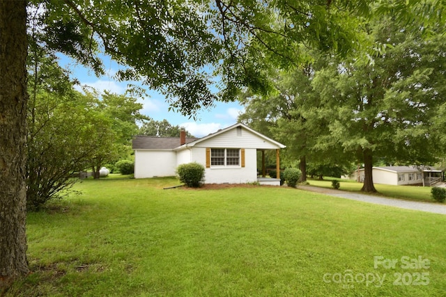 80 Sumner Ave NW, Concord, NC 28027 - view of front of property with a front yard and a chimney