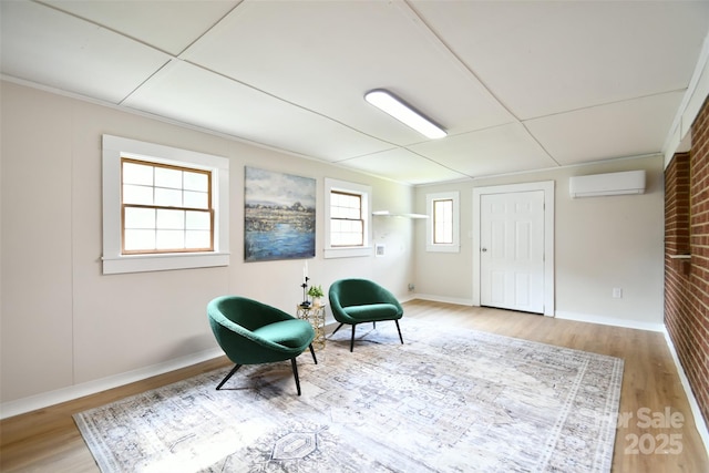 80 Sumner Ave NW, Concord, NC 28027 - sitting room featuring a wall unit AC and wood finished floors
