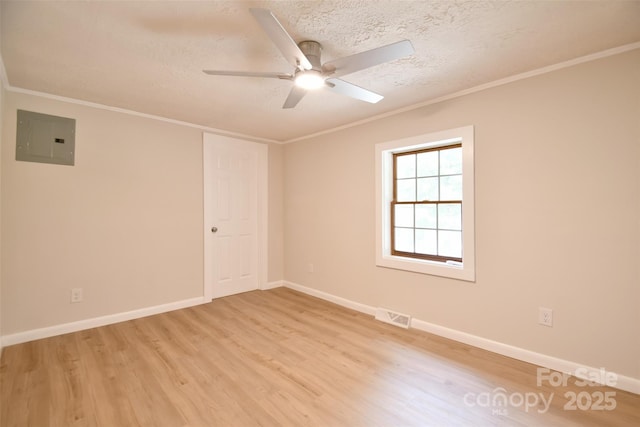 80 Sumner Ave NW, Concord, NC 28027 - spare room featuring electric panel, light wood finished floors, a ceiling fan, ornamental molding, and a textured ceiling