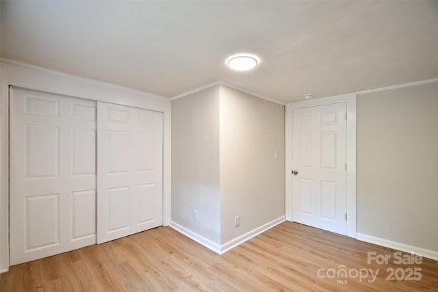 80 Sumner Ave NW, Concord, NC 28027 - unfurnished bedroom featuring light wood-type flooring, ornamental molding, and a closet