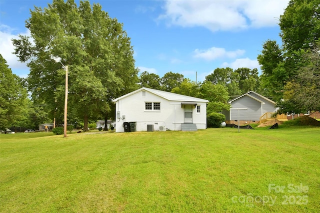 80 Sumner Ave NW, Concord, NC 28027 - rear view of property with a lawn and view of wooded area