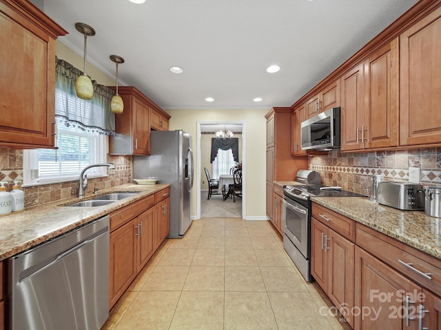1302 Hawthorne Rd, Lancaster, SC 29720 - kitchen with stainless steel appliances, brown cabinets, light stone countertops, backsplash, and recessed lighting