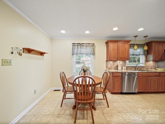 1302 Hawthorne Rd, Lancaster, SC 29720 - kitchen with stainless steel dishwasher, backsplash, healthy amount of natural light, ornamental molding, and pendant lighting