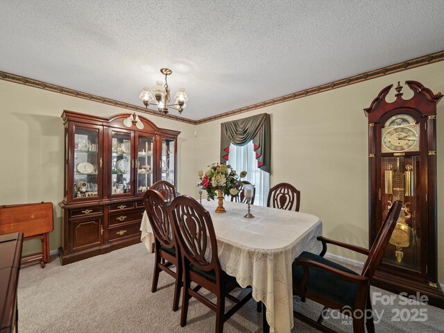 1302 Hawthorne Rd, Lancaster, SC 29720 - dining space featuring a chandelier, a textured ceiling, ornamental molding, and light colored carpet