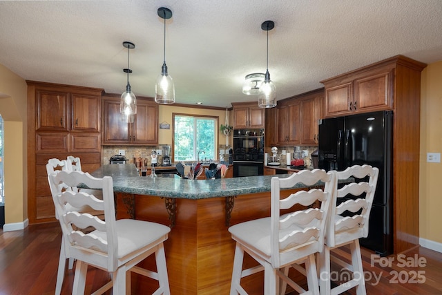 135 Primrose Dr, Salisbury, NC 28147 - kitchen with black appliances, brown cabinets, decorative backsplash, dark wood-type flooring, and a textured ceiling