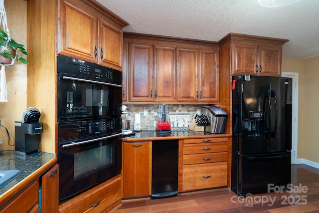 135 Primrose Dr, Salisbury, NC 28147 - kitchen with black appliances, brown cabinets, backsplash, dark wood finished floors, and a textured ceiling