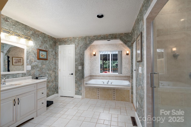 135 Primrose Dr, Salisbury, NC 28147 - full bath featuring vanity, tile patterned flooring, a garden tub, a textured ceiling, and a shower stall