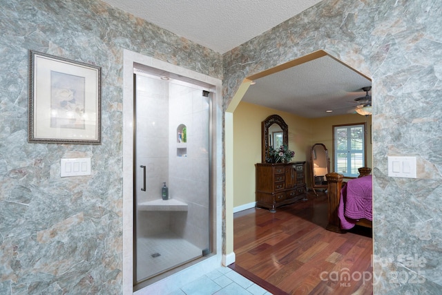 135 Primrose Dr, Salisbury, NC 28147 - full bath with a textured ceiling, a shower stall, ensuite bath, ceiling fan, and wood finished floors