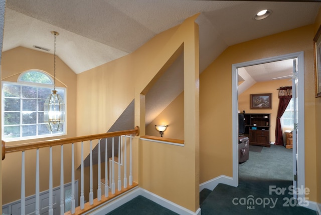 135 Primrose Dr, Salisbury, NC 28147 - hallway with vaulted ceiling, carpet floors, a chandelier, a textured ceiling, and an upstairs landing