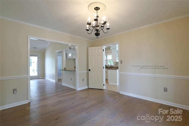 8829 Gelligum Dr, Charlotte, NC 28277 - unfurnished room featuring a chandelier, wood finished floors, and crown molding