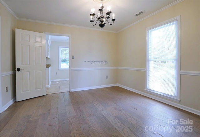 8829 Gelligum Dr, Charlotte, NC 28277 - empty room featuring a chandelier, wood finished floors, and ornamental molding