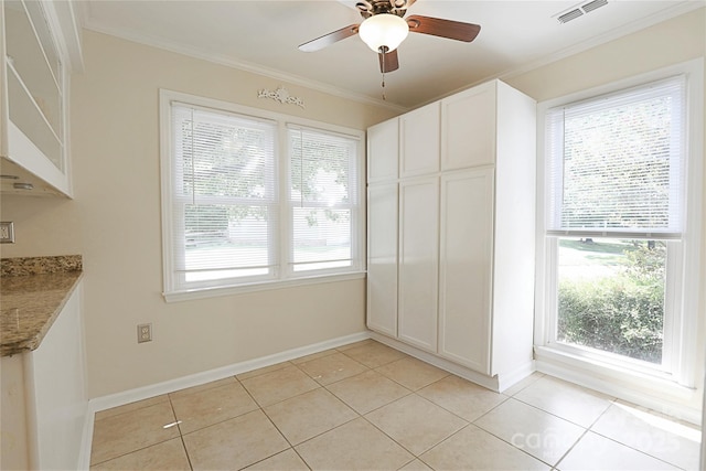 8829 Gelligum Dr, Charlotte, NC 28277 - unfurnished dining area with healthy amount of natural light, ornamental molding, a ceiling fan, and light tile patterned flooring