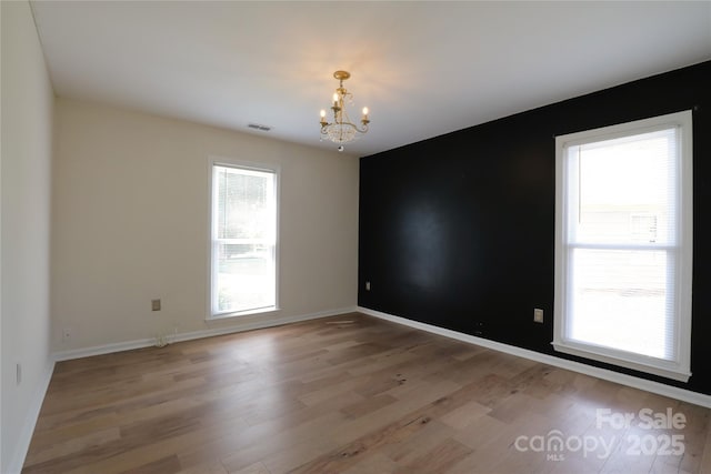8829 Gelligum Dr, Charlotte, NC 28277 - spare room with a chandelier and light wood-style flooring